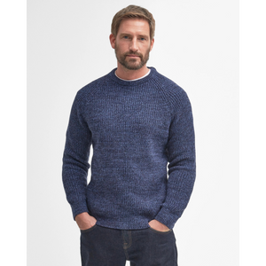 Tässä villaneuleessa on pitkät hihat ja joustavat ribbiresorit hihansuissa. helmassa ja pääntiessä.