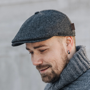 Tämä tummanharmaa flat cap on valmistettu 100% merinovillakankaasta ja on siksi pehmeä, hengittävä ja lämmin.