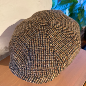 Hatussa on keskellä nappi ja jäykkä, vuorattu lippa pitää muotonsa säällä kuin säällä.