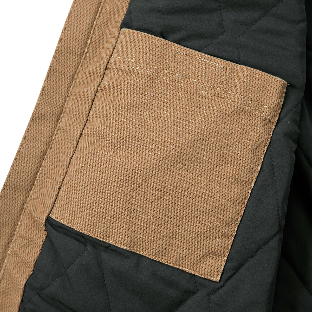 Kuvassa näkyy Carhatt Montana Canvasliivin sisällä oleva tasku. Taskun saa suljettua tarralla. 