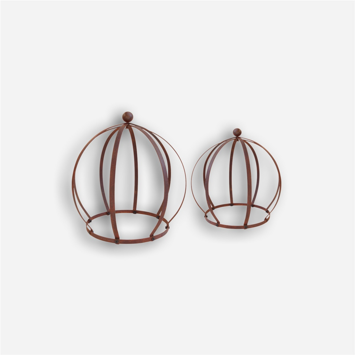 Kuvassa on kaksi erikokoista, ruosteista Ulrika koristepalloa somisteeksi puutarhaan tai ruukkuun.