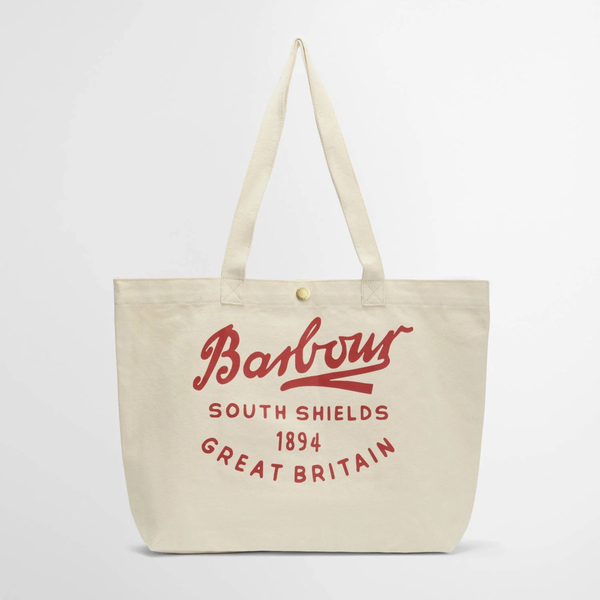 Barbour Script Tote kangaskassissa on punainen näyttävä logo kassin sivussa. Kassissa on nepparikiinnitys.