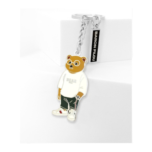 Kuvassa Baron Filou avaimenperä. Siinä on nalle jolla on valkoinen Bearpaita päällä. 