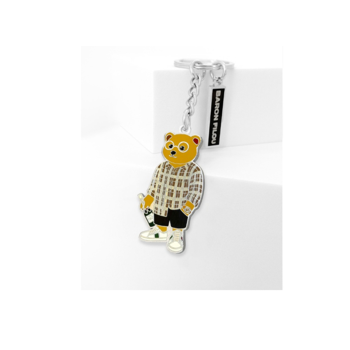 Kuvassa on Baron Filou avaimenperä jossa nallella on shampanjapullo. 