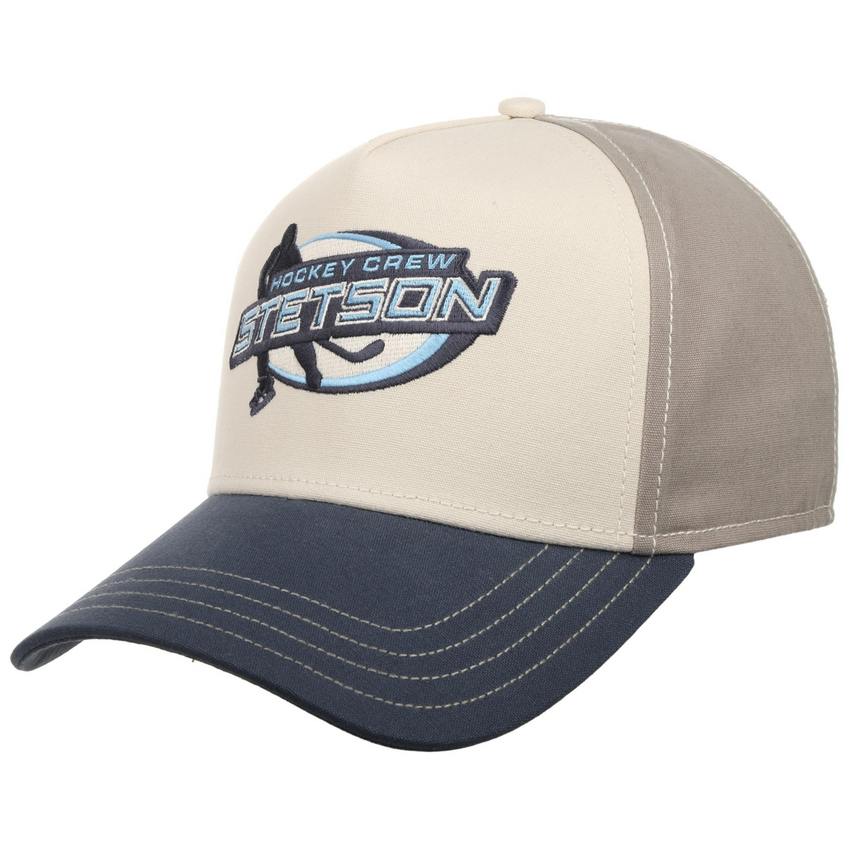 Stetson Trucker Cap Hockey -lippis etuviistosta, luonnonvalkoinen etuosa, harmaat sivut ja tummansininen lippa.